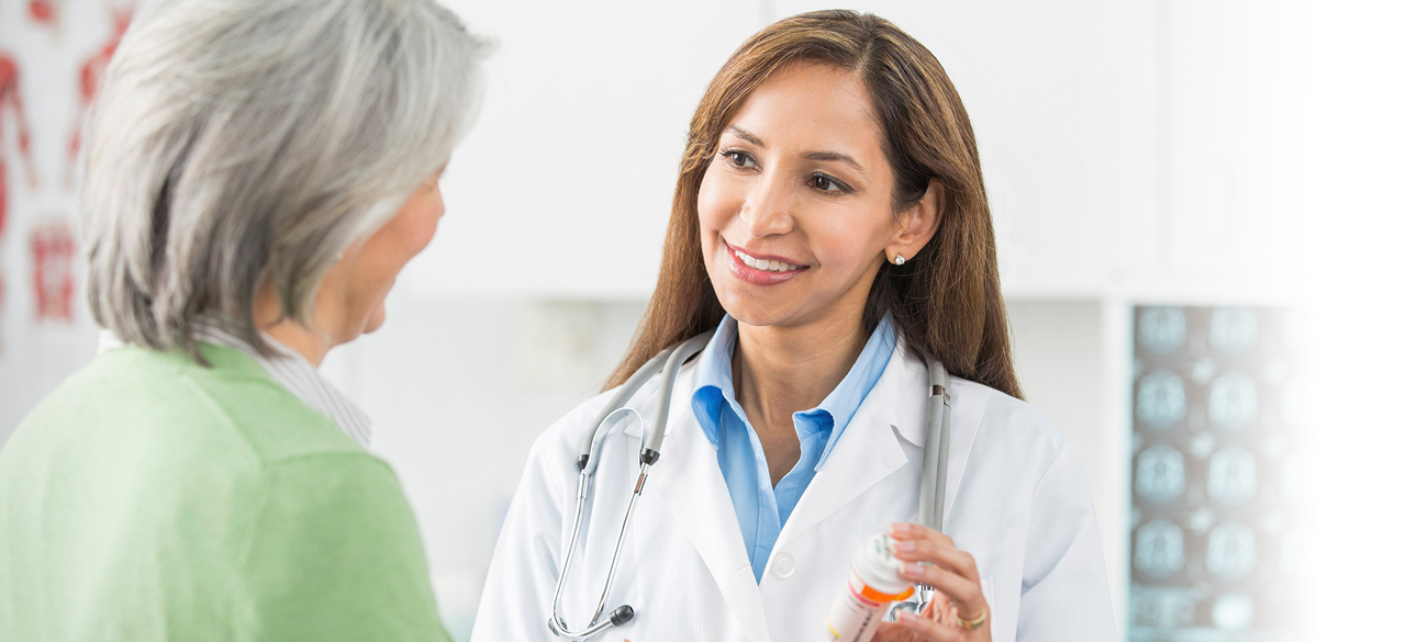 Female doctor speaking to a senior patient