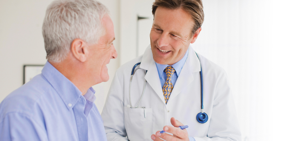 Male doctor speaking to a male patient
