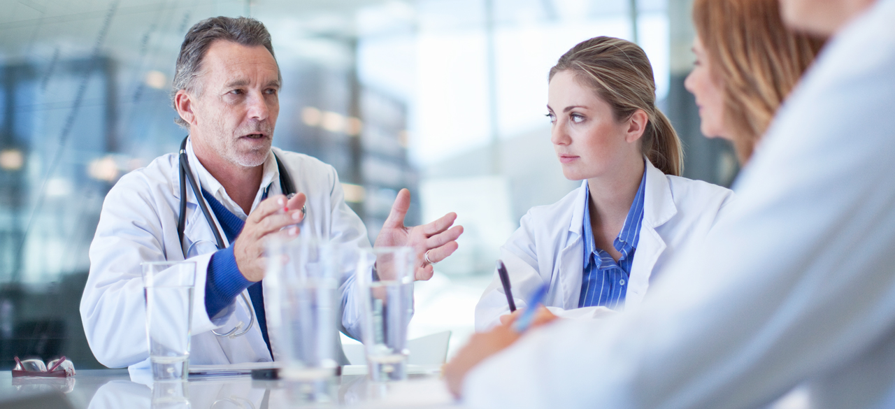 Doctor and collegues sitting at a table