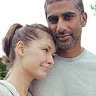 Man with his arm around his wife