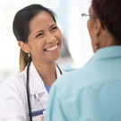 Smiling doctor taking with a patient