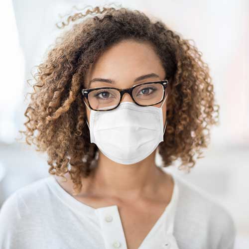 Woman with glasses wearing a mask