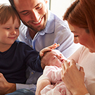 Family looking at baby