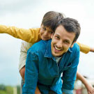 Son laying on fathers back