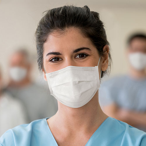 Female medical professional wearing mask and ppe shield
